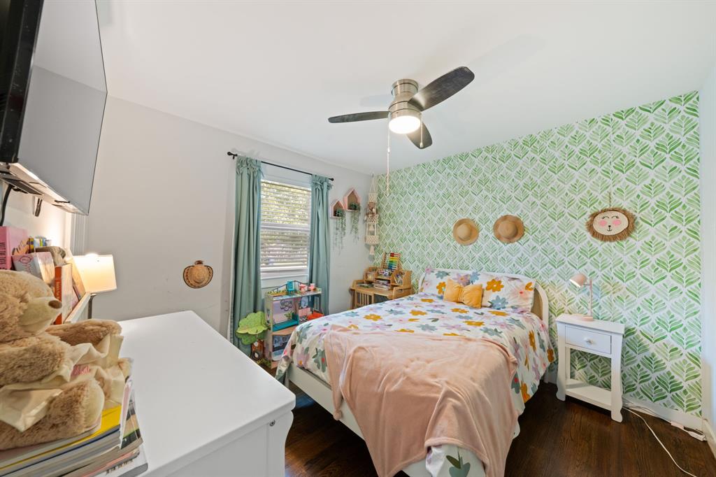 2114 Engle Avenue Dallas, TX 75224 - Photo 16 of 27 a bedroom with a bed and a chandelier