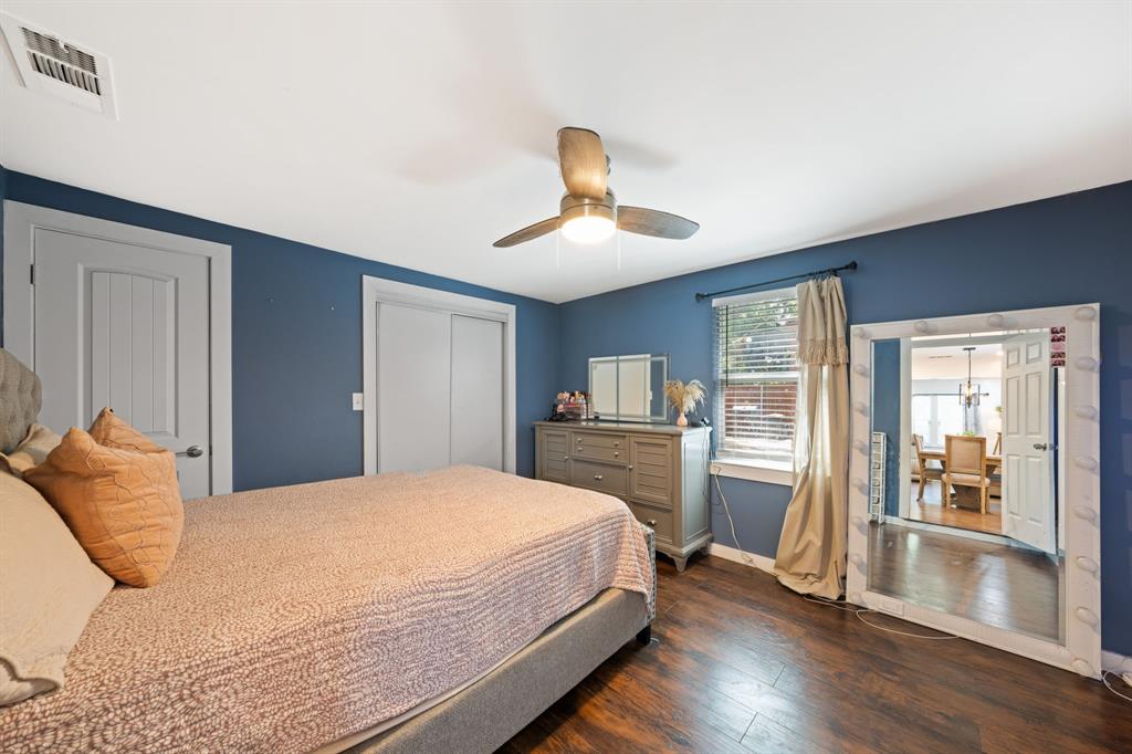 2114 Engle Avenue Dallas, TX 75224 - Photo 18 of 27 a bedroom with a bed and wooden floor