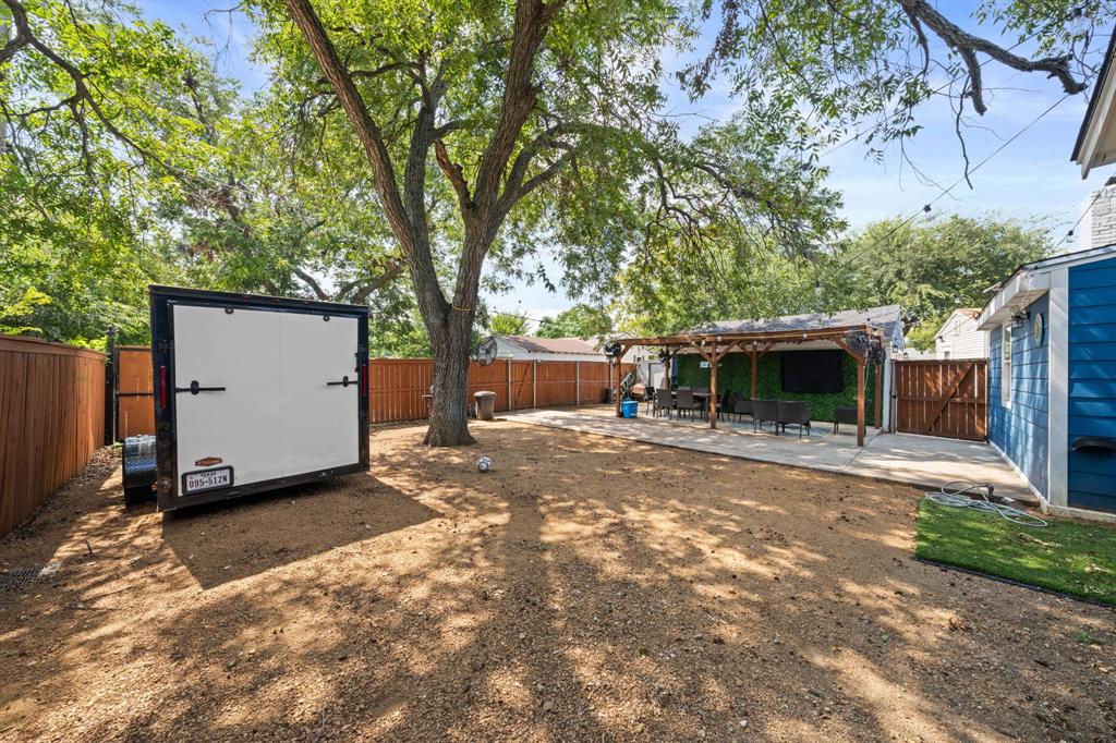 2114 Engle Avenue Dallas, TX 75224 - Photo 23 of 27 a front view of a house with a yard and a large tree