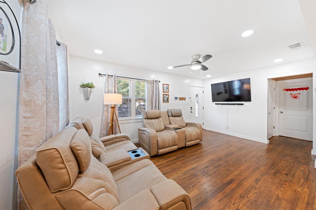 2114 Engle Avenue Dallas, TX 75224 - Photo 3 of 27 a living room with furniture a flat screen tv and kitchen view