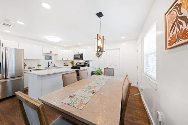 a kitchen with refrigerator cabinets and wooden floor