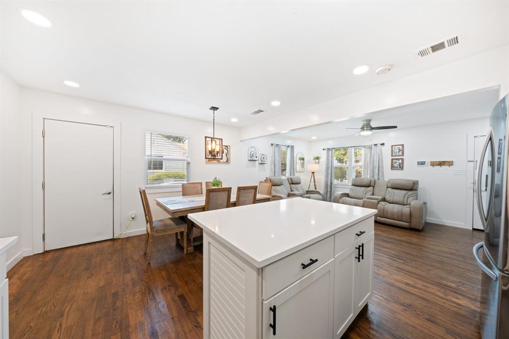 2114 Engle Avenue Dallas, TX 75224 - Photo 26 of 27 a large white kitchen with a table and chairs