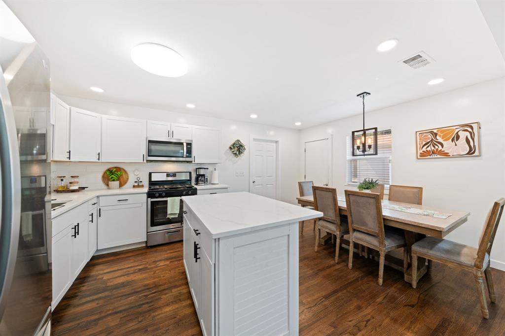 2114 Engle Avenue Dallas, TX 75224 - Photo 8 of 27 a kitchen with a table chairs stove and microwave