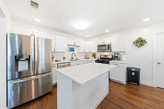 a kitchen with a table chairs stove and microwave