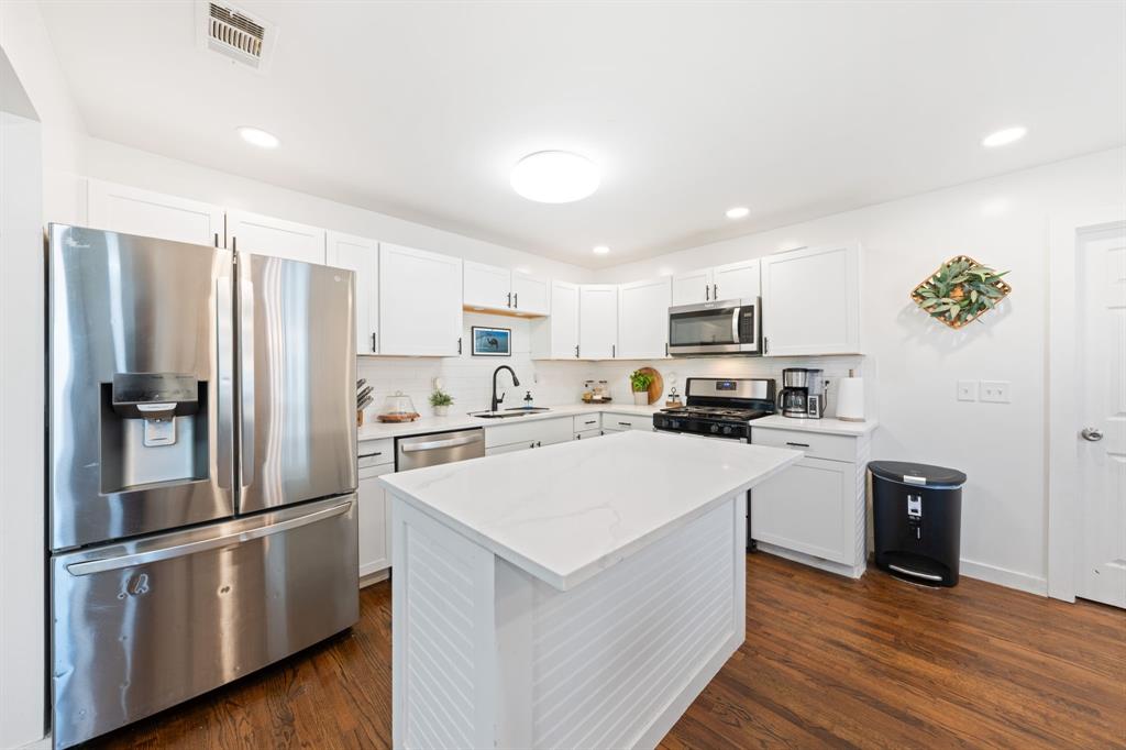 2114 Engle Avenue Dallas, TX 75224 - Photo 9 of 27 a kitchen with stainless steel appliances a refrigerator sink and microwave