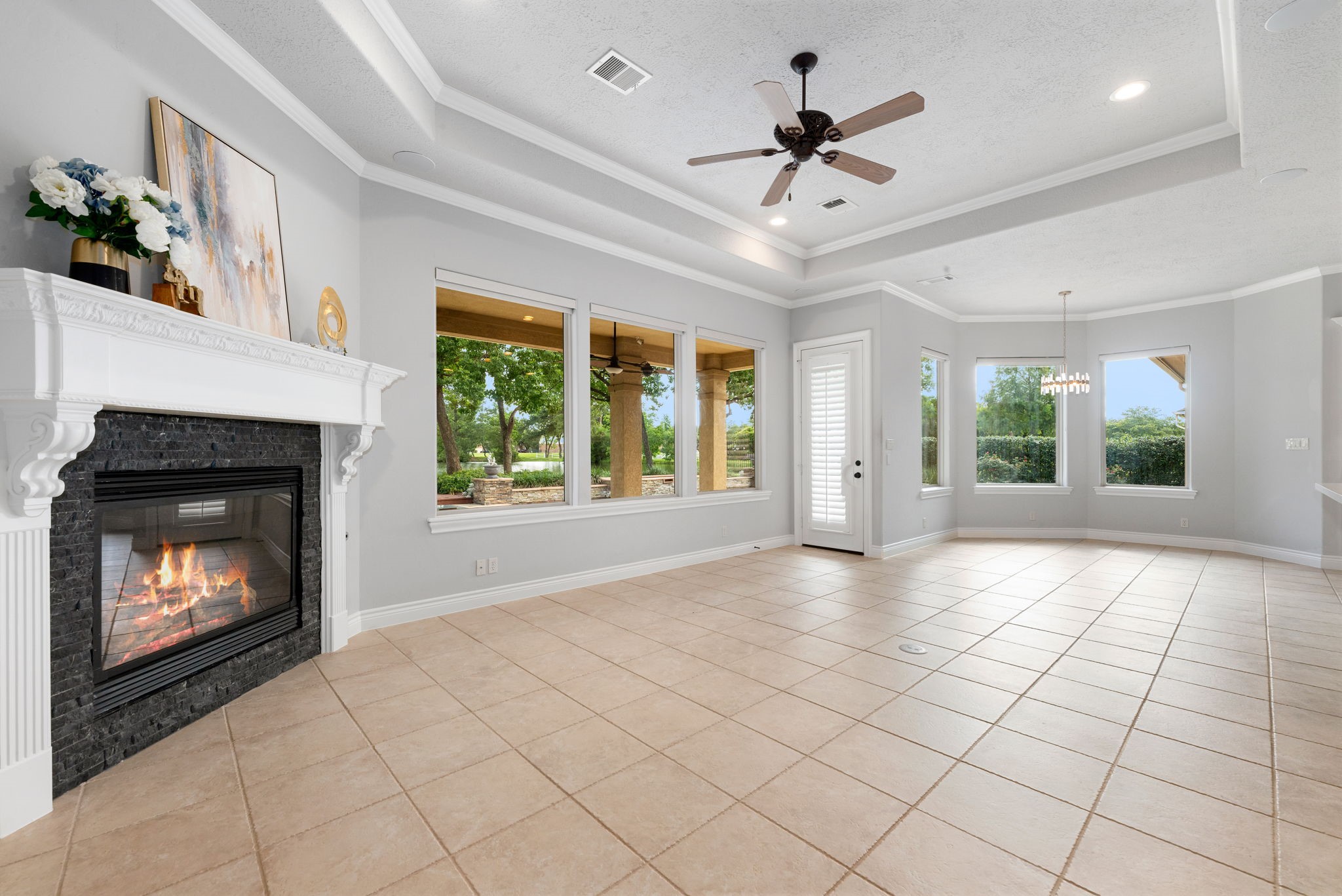 6006 Valhalla Drive Spring, TX 77379 - Photo 5 of 44 Spacious living room surrounded by large windows showcasing stunning lake and backyard views.