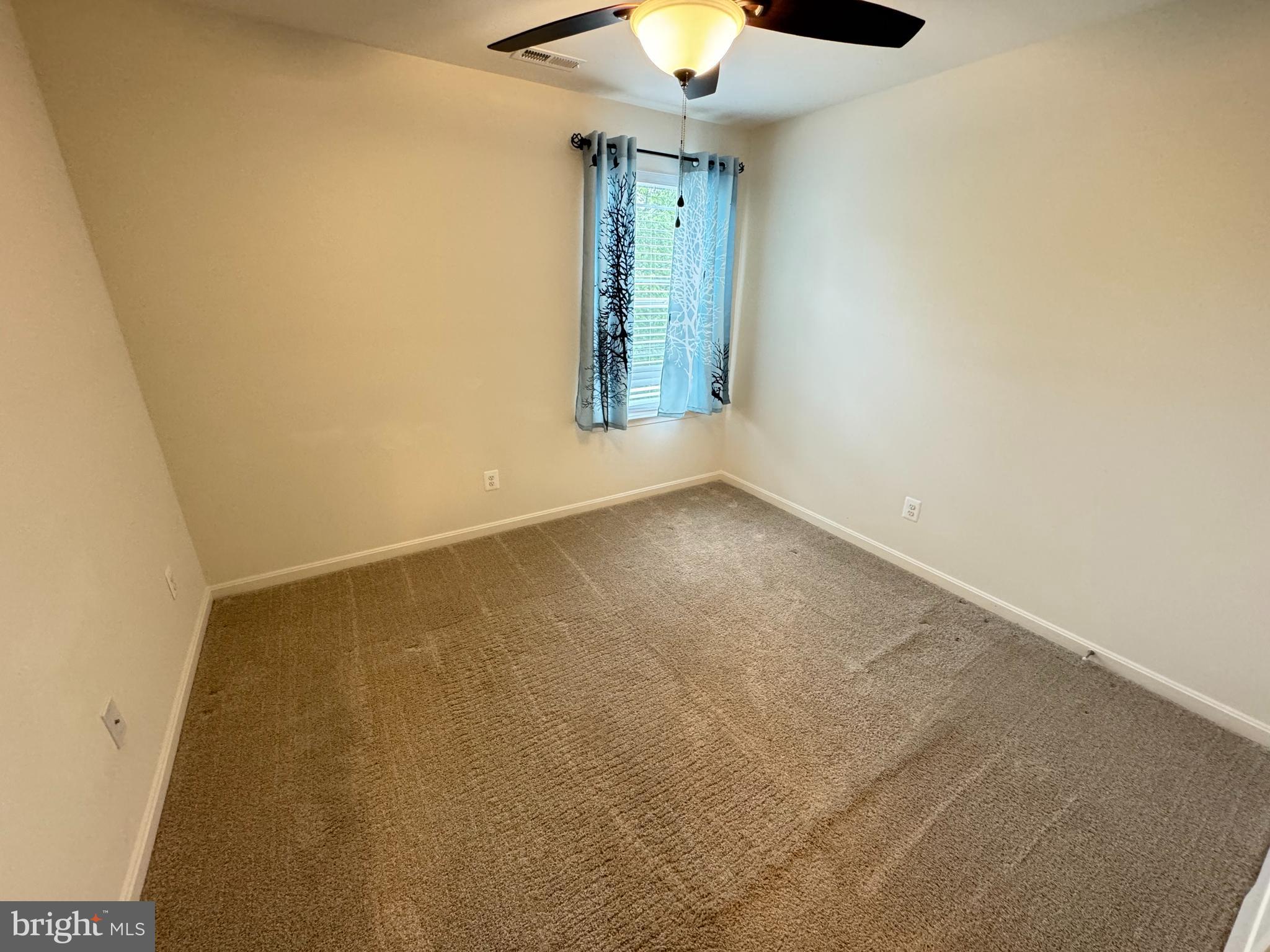 1003 Chestnut Street Delta, PA 17314 - Photo 14 of 27 an empty room with a window and a chandelier fan