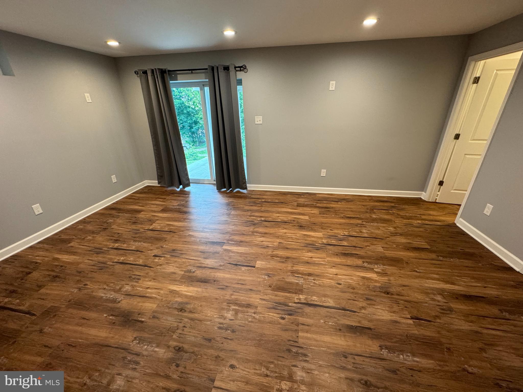1003 Chestnut Street Delta, PA 17314 - Photo 23 of 27 an empty room with wooden floor and entrance