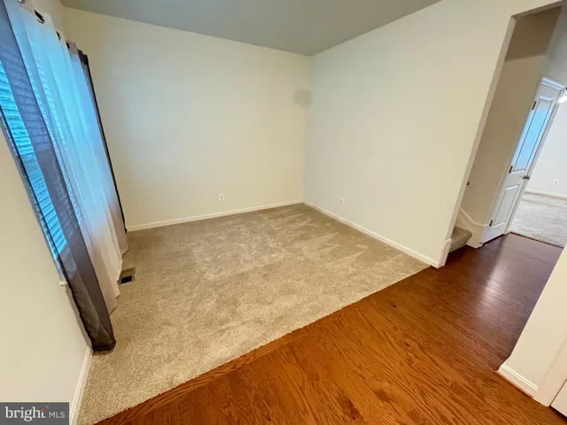 a view of a room with wooden floor and staircase