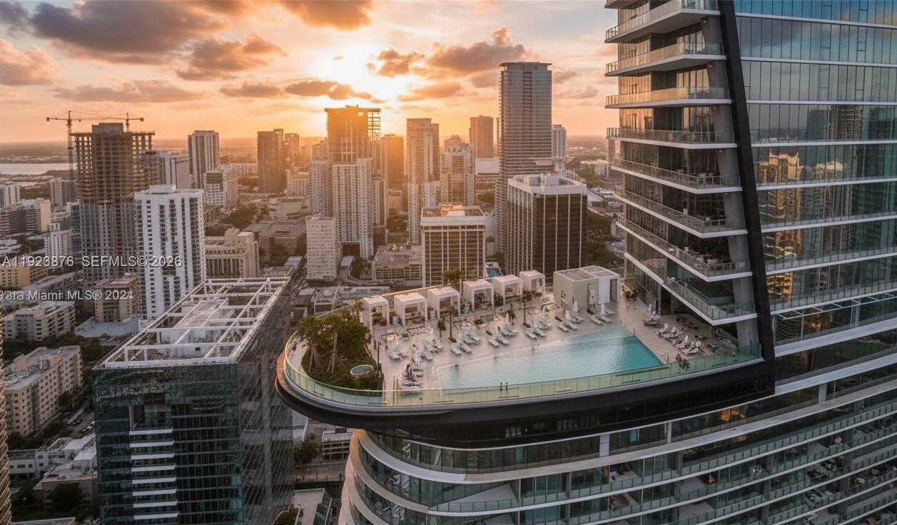 300 Biscayne Blvd Way, Unit 4201 Miami, FL 33131 - Photo 1 of 21 a view of a balcony with a table and chairs and wooden fence
