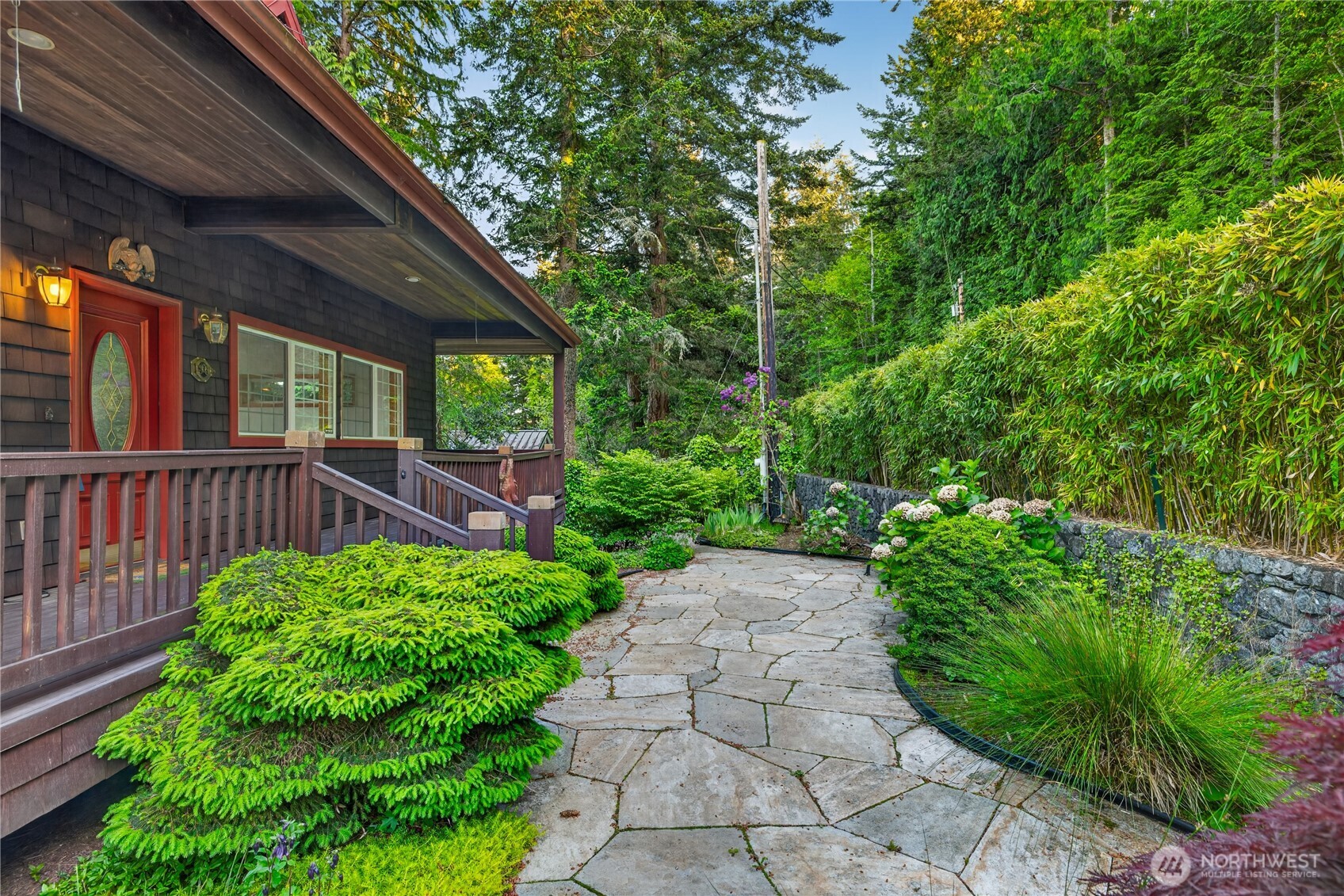 4623 Guemes Island Road Anacortes, WA 98221 - Photo 6 of 40 a view of a backyard with potted plants and floor to ceiling window