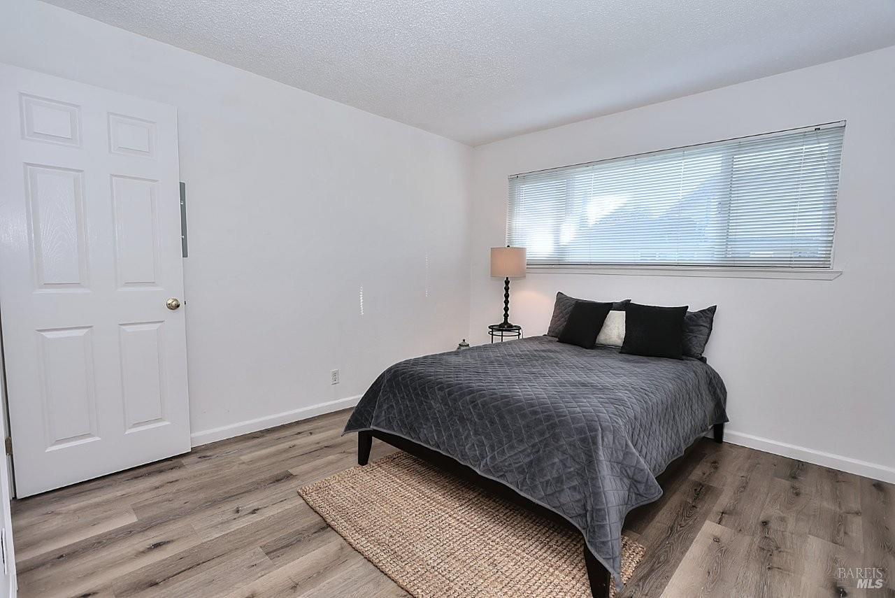 1970 Peabody Road, Unit 1 Vacaville, CA 95687 - Photo 10 of 16 a bedroom with a bed and wooden floor