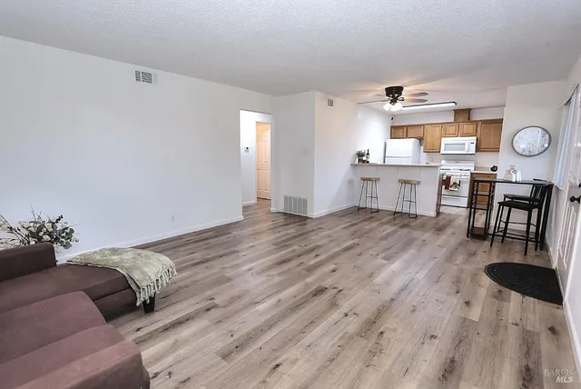 a very nice looking dining room with furniture window and wooden floor
