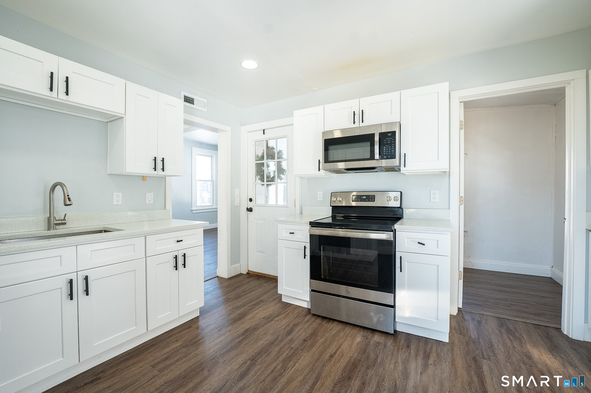 121 Hawthorne Avenue Derby, CT 06418 - Photo 3 of 12 a kitchen with sink a microwave and cabinets