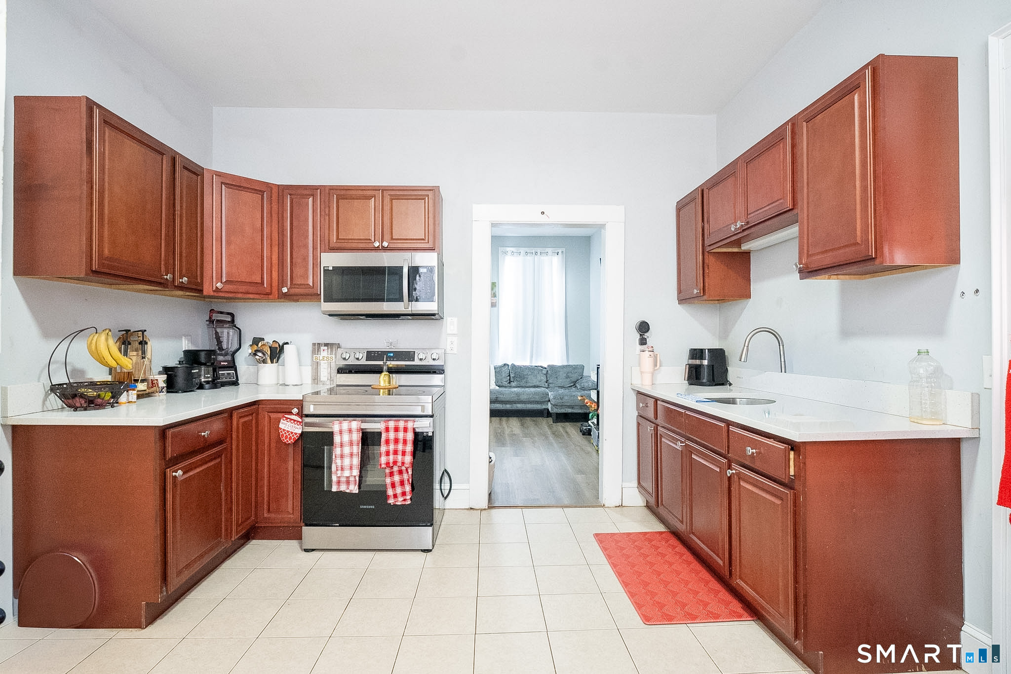 121 Hawthorne Avenue Derby, CT 06418 - Photo 9 of 12 a kitchen with stainless steel appliances granite countertop a stove top oven a sink dishwasher and a refrigerator with cabinets