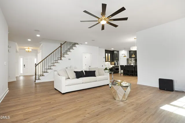a living room with furniture and wooden floor