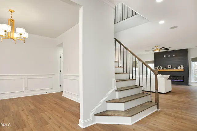 a view of entryway and hall with wooden floor