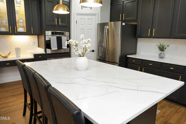a kitchen with a table chairs and refrigerator