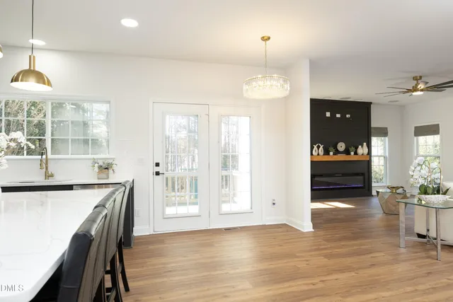 an open kitchen with granite countertop a stove and a wooden floors