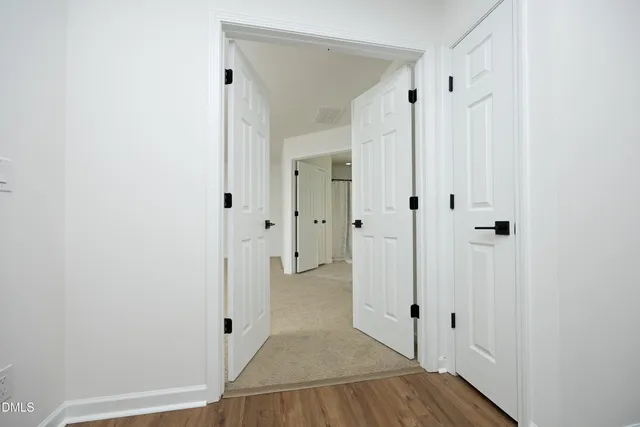 a view of a hallway with wooden floor