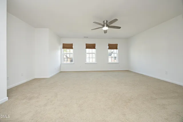 a view of an empty room with windows