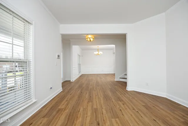 a view of a room with wooden floor and windows