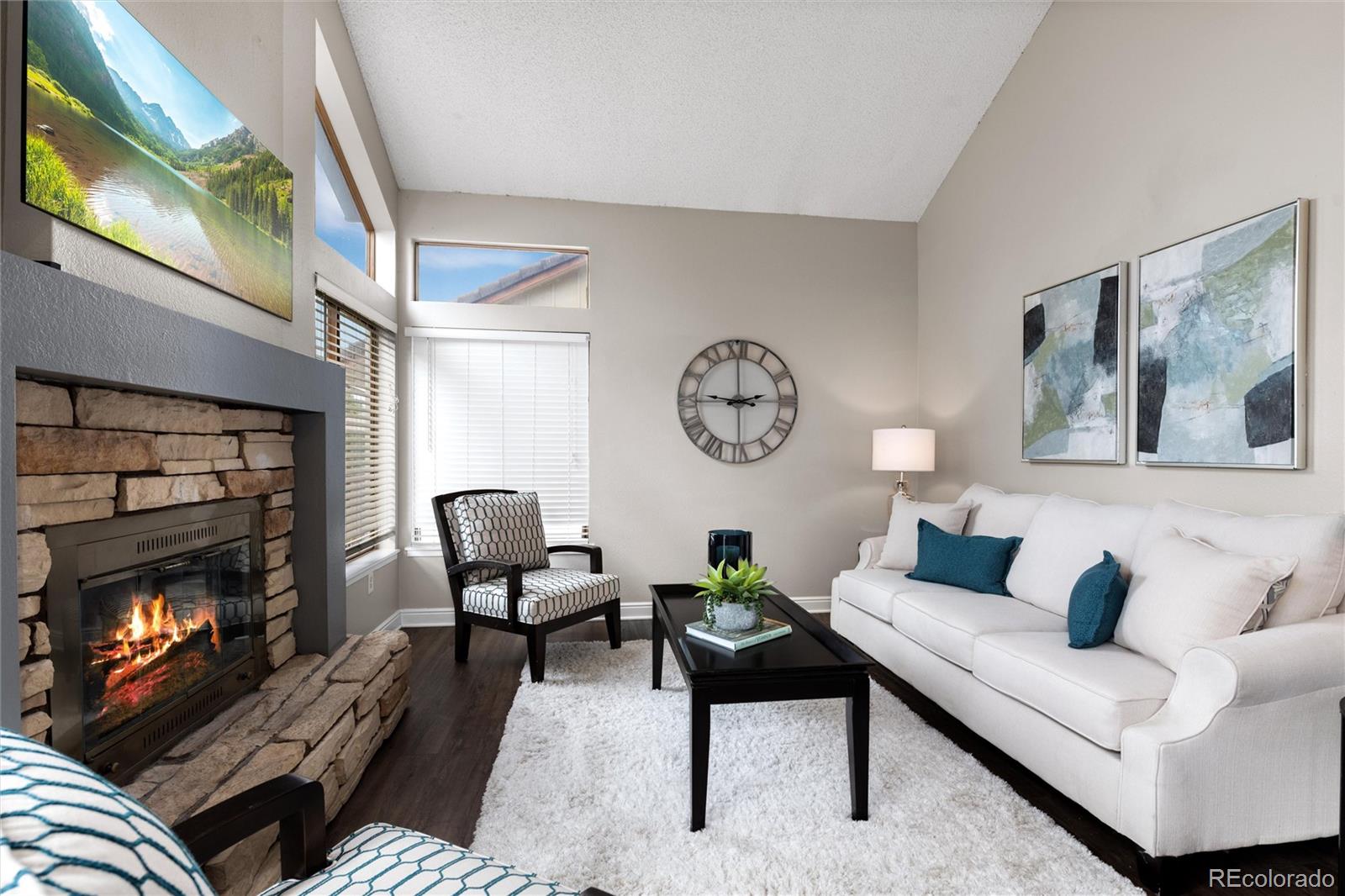 1225 East Goldsmith Drive Highlands Ranch, CO 80126 - Photo 18 of 40 a living room with furniture fireplace and a flat screen tv