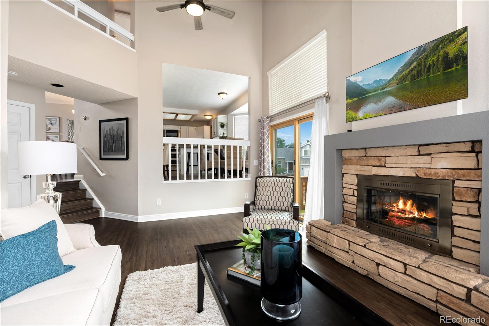 1225 East Goldsmith Drive Highlands Ranch, CO 80126 - Photo 19 of 40 a living room with furniture and a fireplace