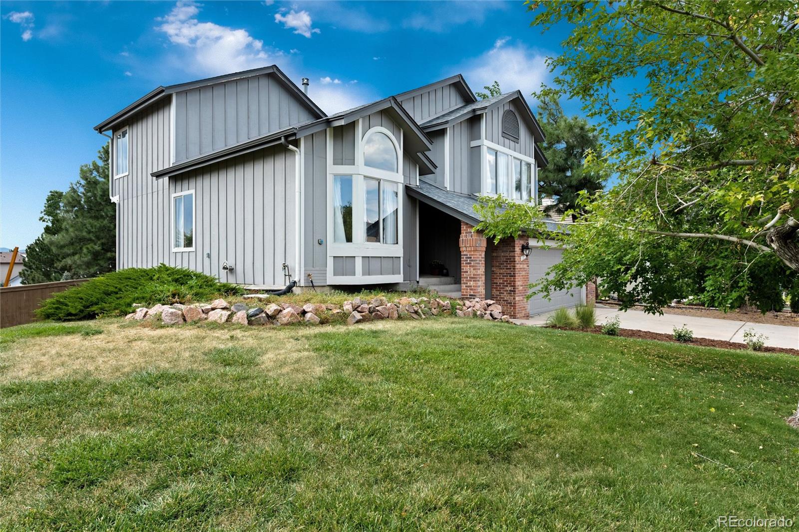 1225 East Goldsmith Drive Highlands Ranch, CO 80126 - Photo 2 of 40 a view of a house with backyard and garden
