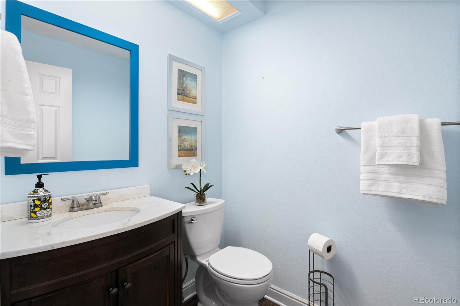 1225 East Goldsmith Drive Highlands Ranch, CO 80126 - Photo 22 of 40 a bathroom with a granite countertop toilet sink and mirror