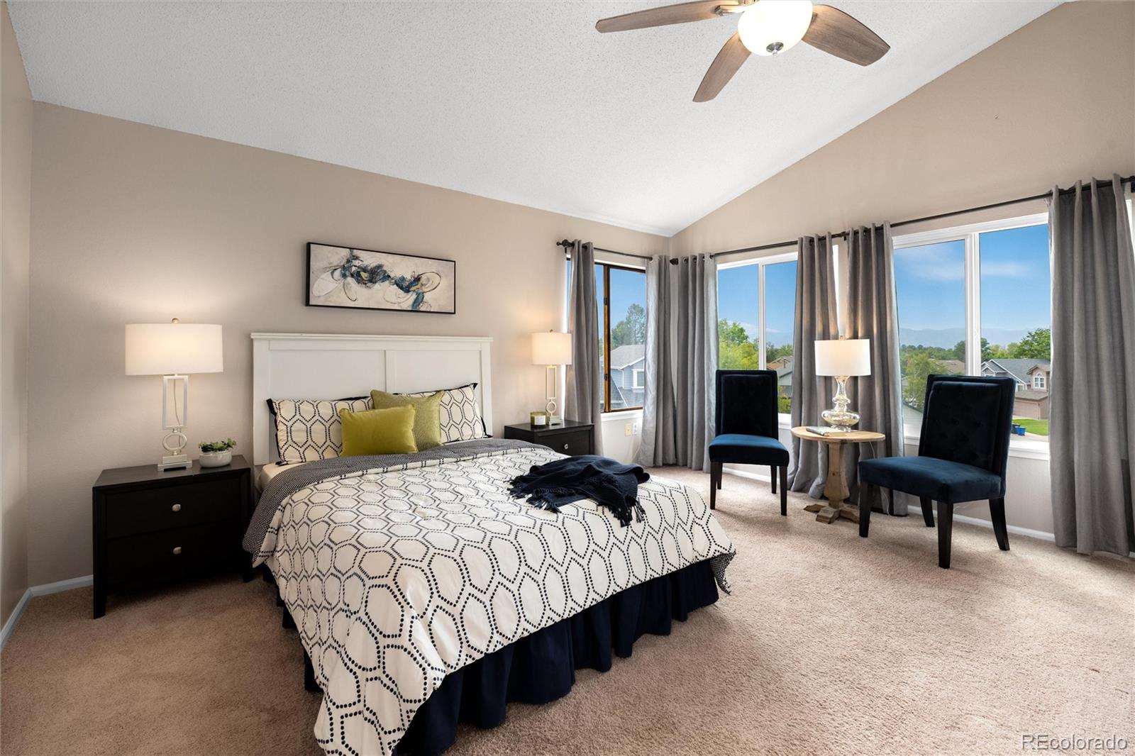 1225 East Goldsmith Drive Highlands Ranch, CO 80126 - Photo 23 of 40 a bedroom with a bed and a chandelier