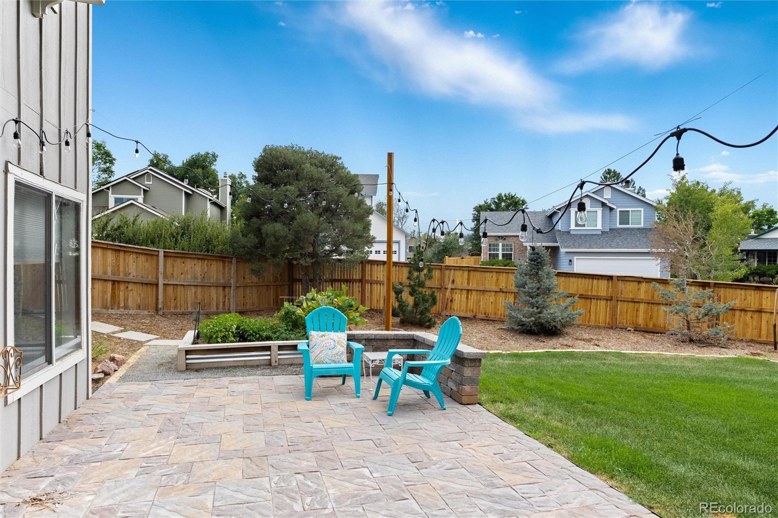 1225 East Goldsmith Drive Highlands Ranch, CO 80126 - Photo 35 of 40 a view of a chair and table in backyard of the house