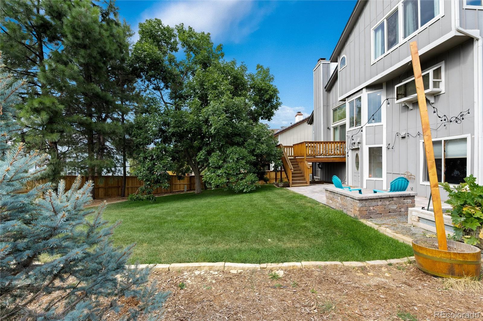 1225 East Goldsmith Drive Highlands Ranch, CO 80126 - Photo 37 of 40 a front view of a house with a garden and plants