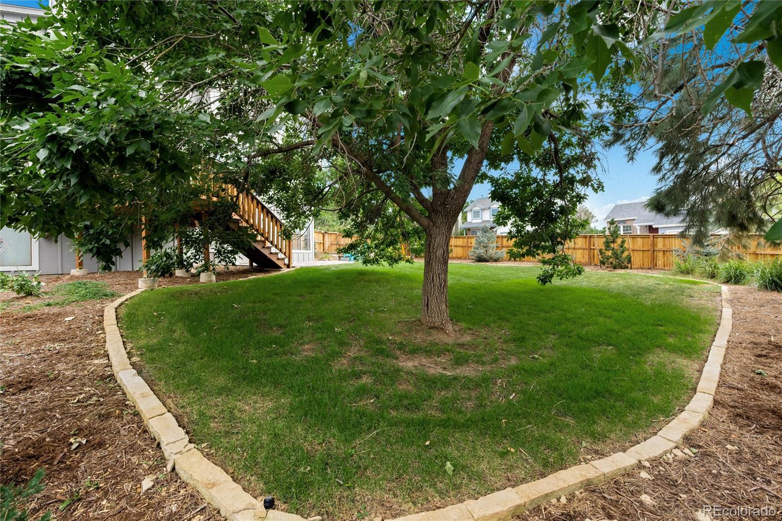 1225 East Goldsmith Drive Highlands Ranch, CO 80126 - Photo 38 of 40 a view of a yard with large trees