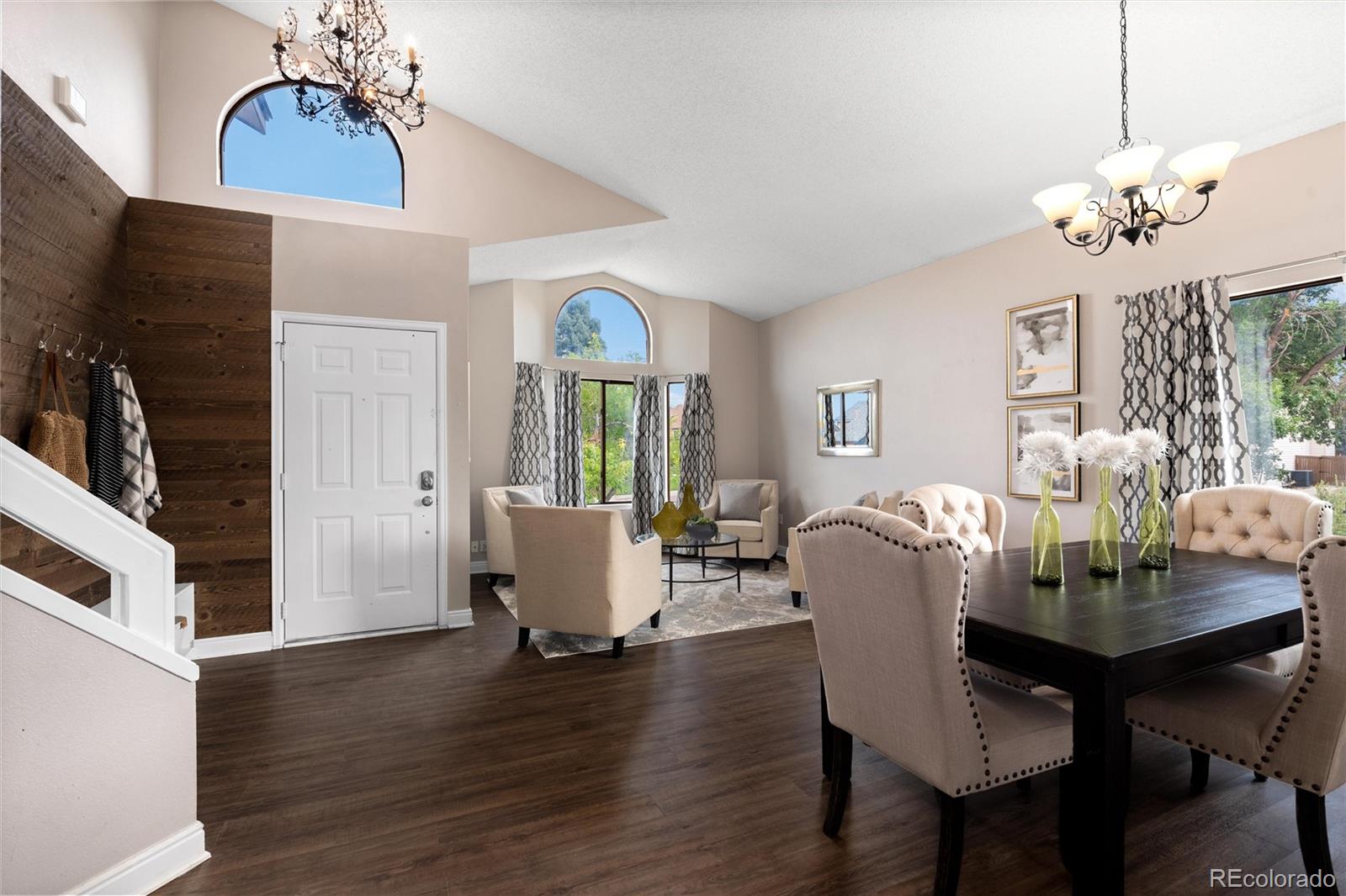 1225 East Goldsmith Drive Highlands Ranch, CO 80126 - Photo 8 of 40 a dining room with furniture a chandelier and wooden floor