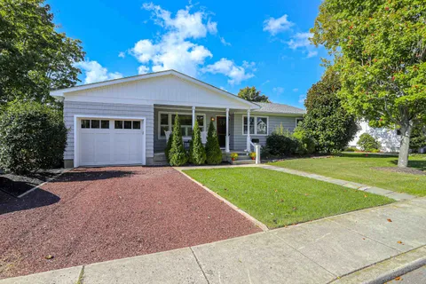a front view of house with yard and green space