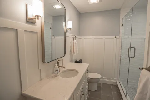 a bathroom with a sink toilet and shower