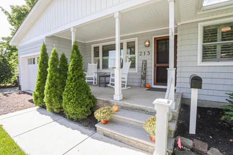 a front view of a house with outdoor seating