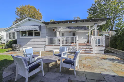 a view of a house with backyard and sitting area