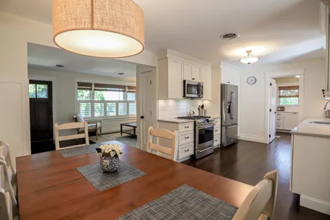 a kitchen with stainless steel appliances granite countertop a sink refrigerator and cabinets