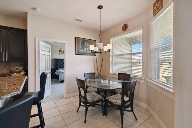 a dining room with furniture and window