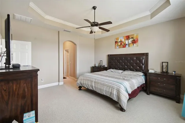 a bedroom with bed and wooden floor