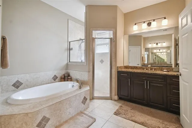 a bathroom with a tub sink and mirror