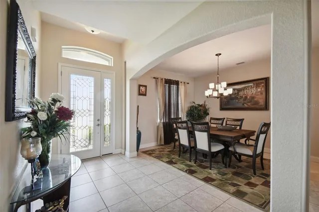 a view of a dining room with furniture and a chandelier