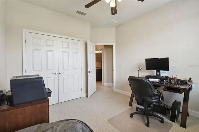 a view of a livingroom with workspace and a couch
