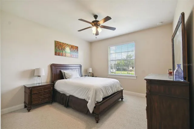a bedroom with a bed window and a wall painting