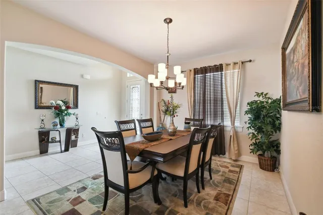 a view of a dining room with furniture and chandelier