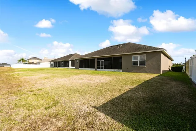a view of an house with swimming pool and yard