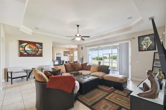 a living room with furniture a chandelier and a rug