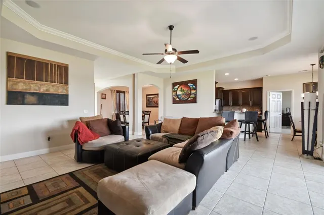 a living room with furniture a ceiling fan and a rug